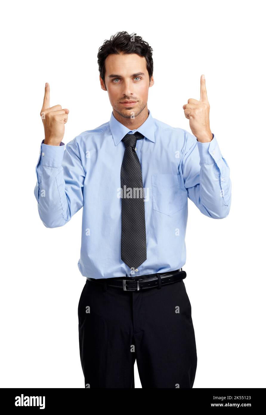 The answers right up here. A serious young businessman pointing upwards while looking at you. Stock Photo