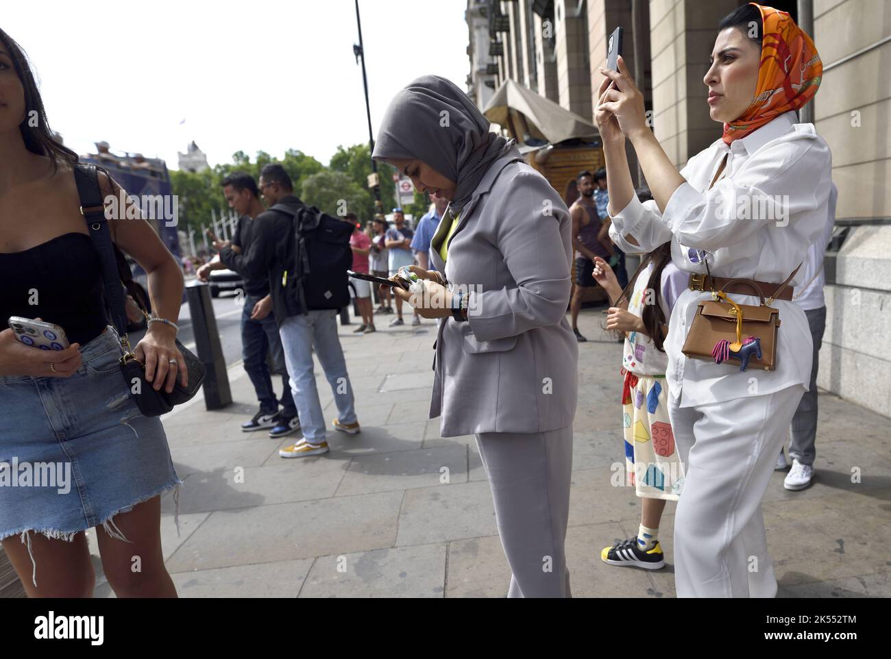 London, England, UK. Asian women using mobile phones in Westminster