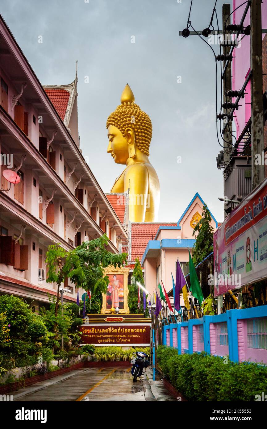 The giant golden Buddha looms large above the city of Bangkok Thailand at Wat Paknam. Temple full name; Wat Pak Nam Phasi Cheroen. Stock Photo