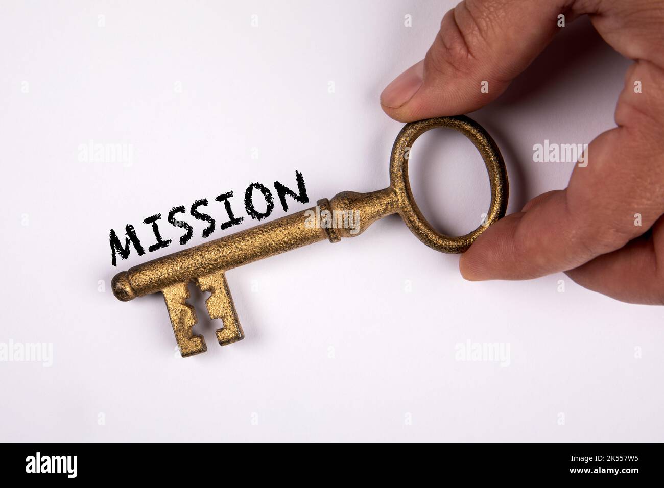 Mission concept. Golden key in a man's hand on a white background Stock ...