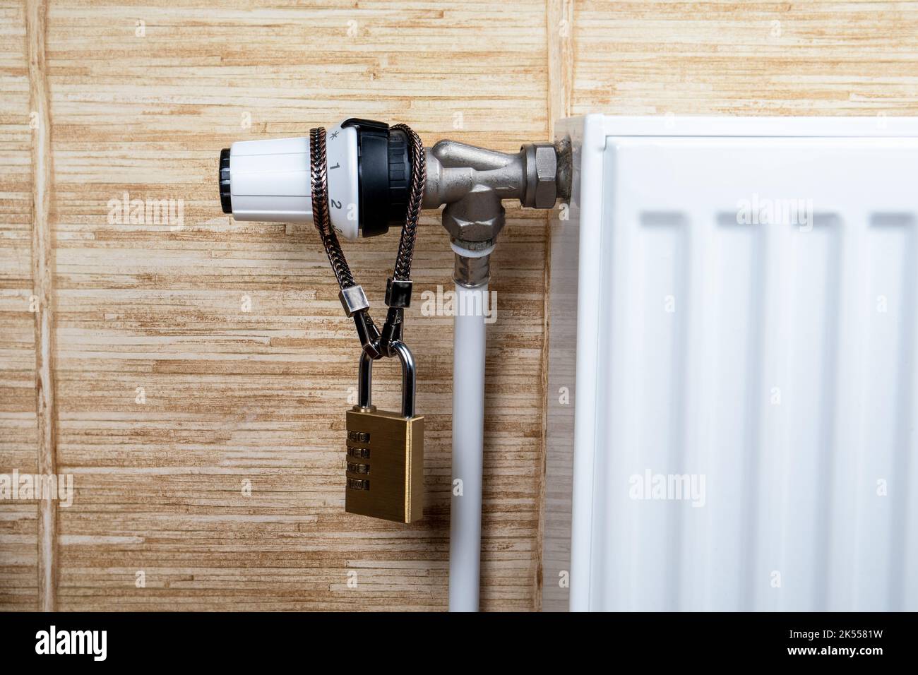 Padlock with chain to heating radiators. Heating costs and saving concept. Stock Photo