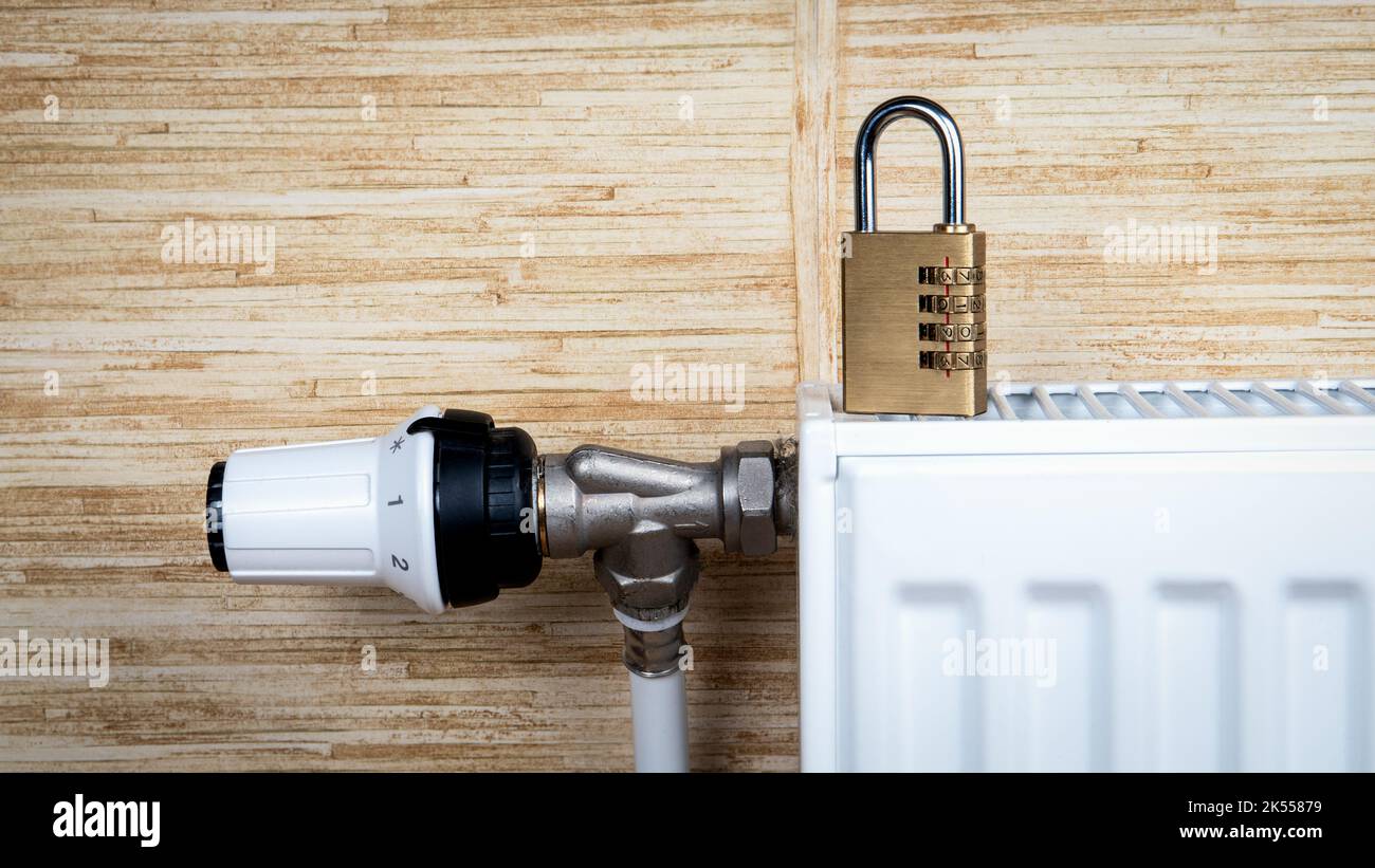 Heating season concept. Padlock on heating radiators Stock Photo Alamy