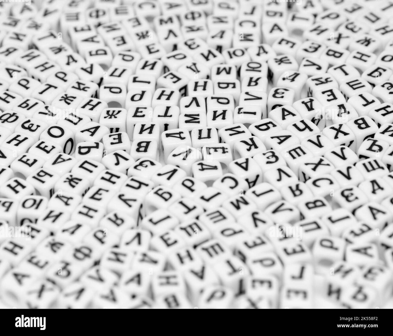 scattered cyrilic letters on white background black and white photo Stock Photo