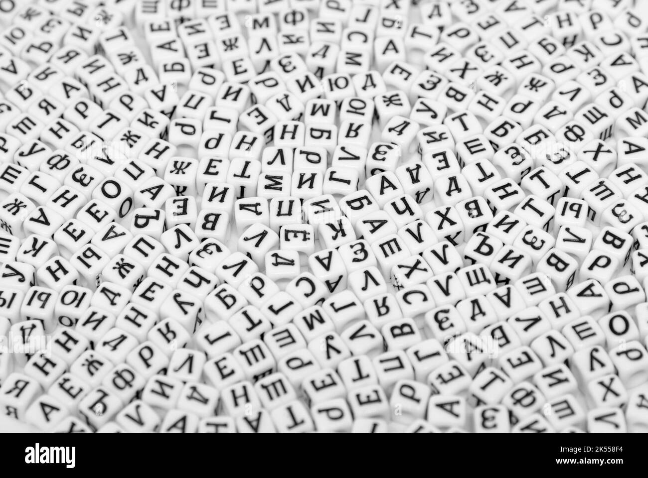 scattered cyrilic letters on white background black and white photo Stock Photo