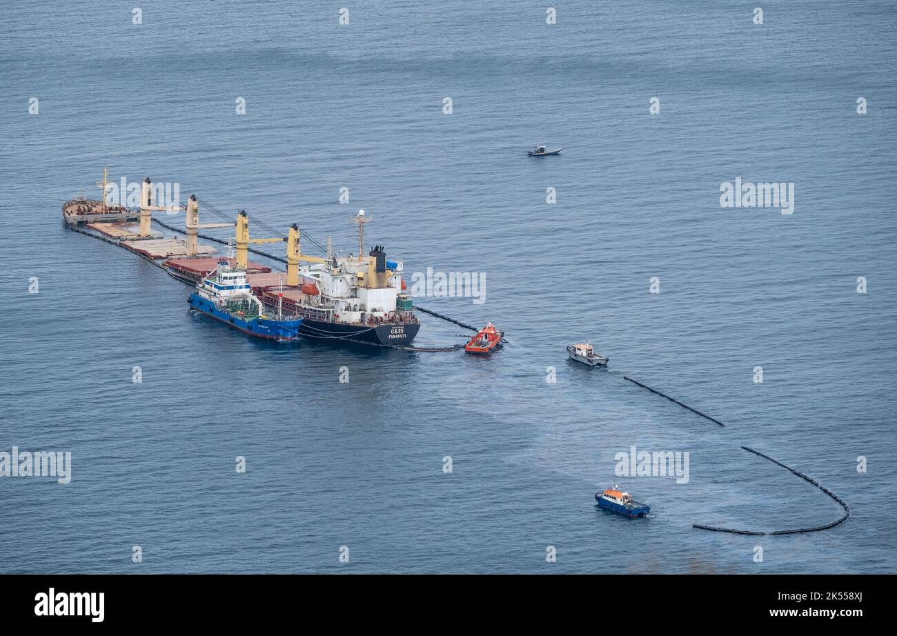 The OS35 bulk carrier which collided with the Adam LNG tanker off Gibraltar, lies beached near Catalan Bay, as crews clean & prevent the spread of oil. Stock Photo