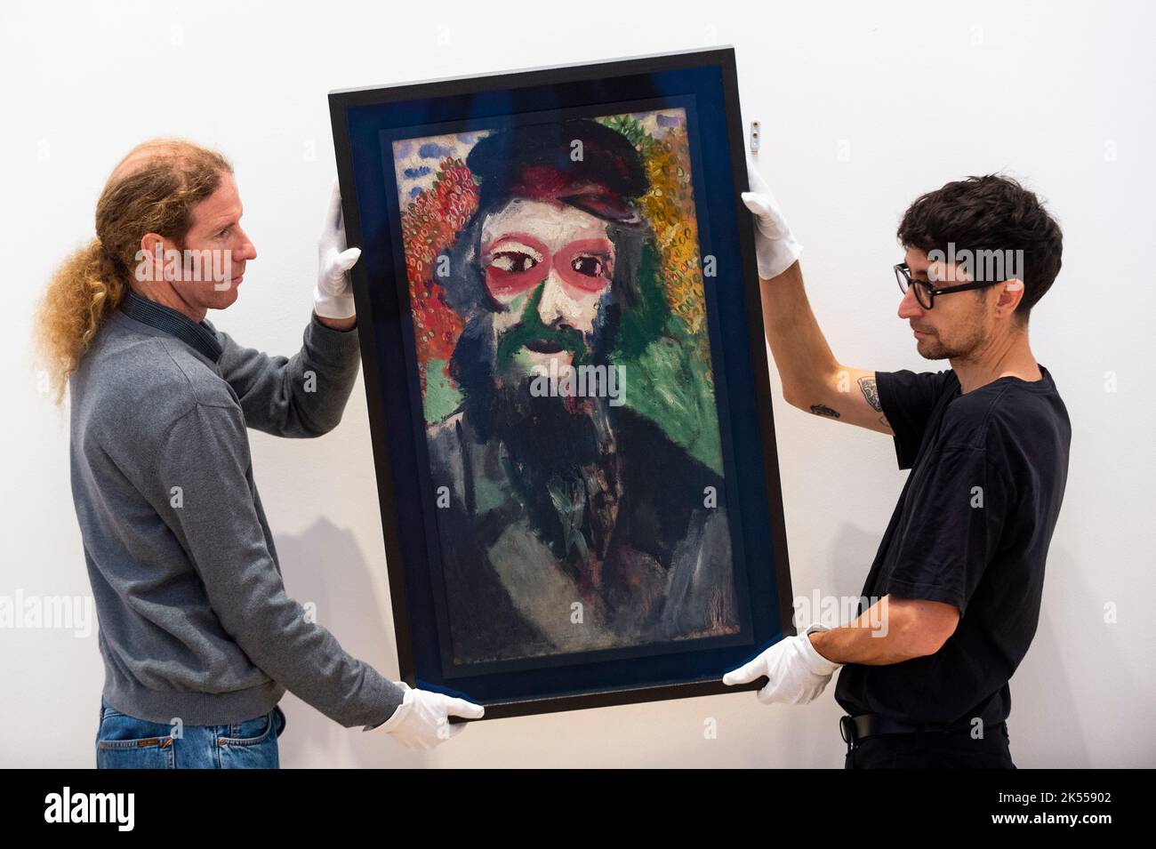 London, UK. 6 October 2022. Technicians hang Marc Chagall’s “Portrait ...