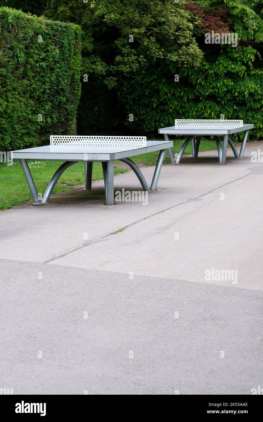 All weather table tennis tables in a park with no one playing on them
