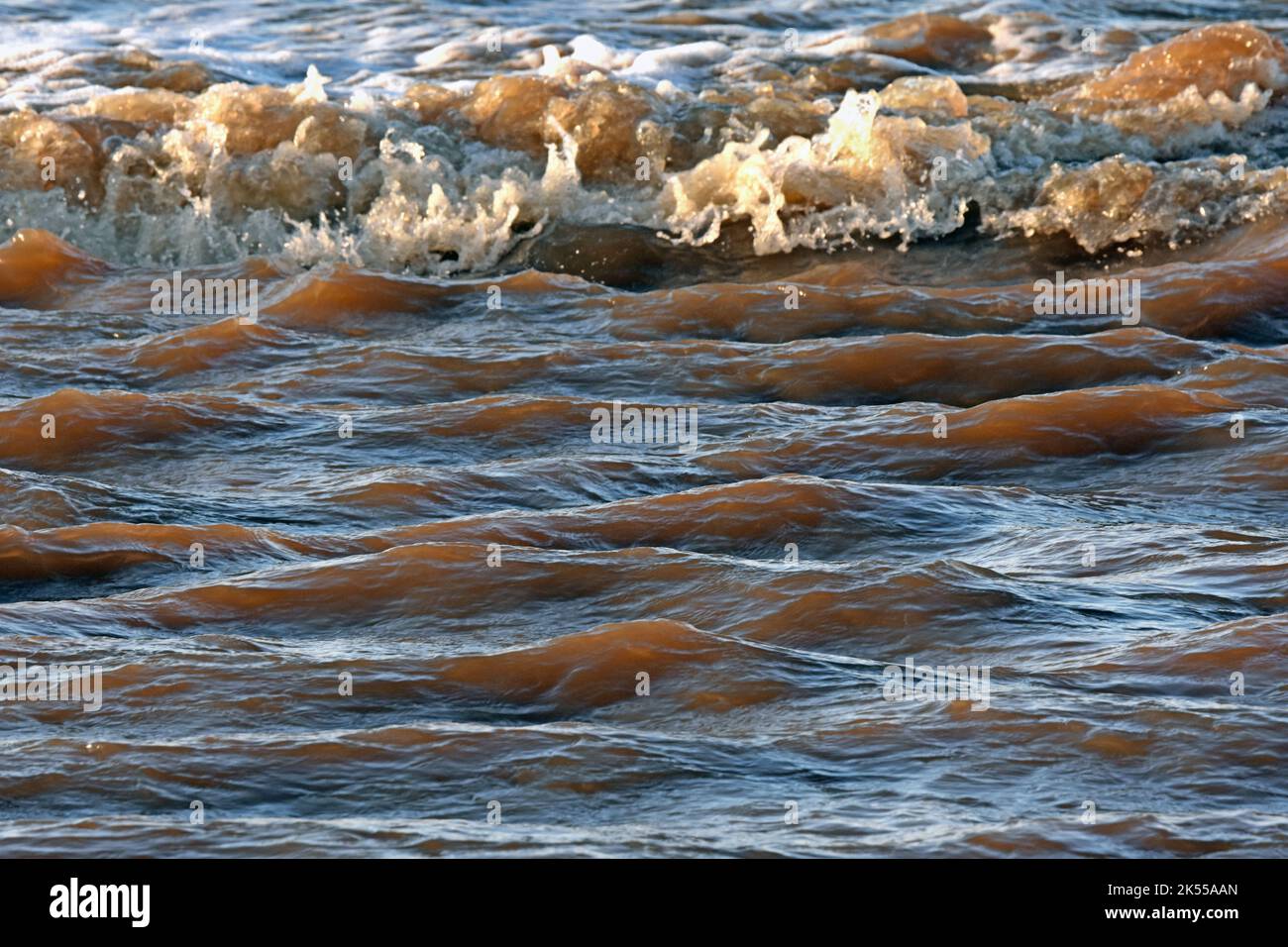 Silt flowing to sea Stock Photo