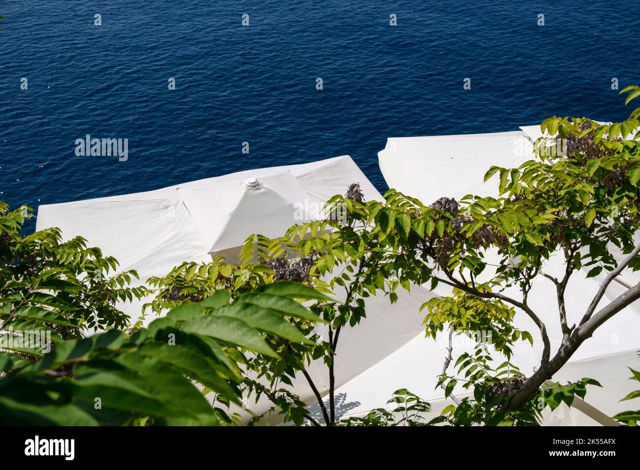 Large white parasols and umbrellas on the adriatic coast used for shade