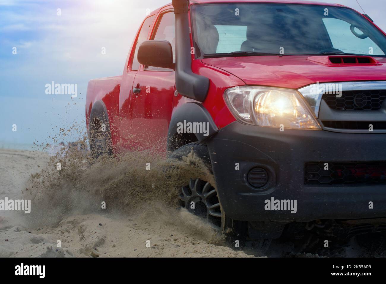 Offroad vehicle bashing through sand dunes in the desert Stock Photo
