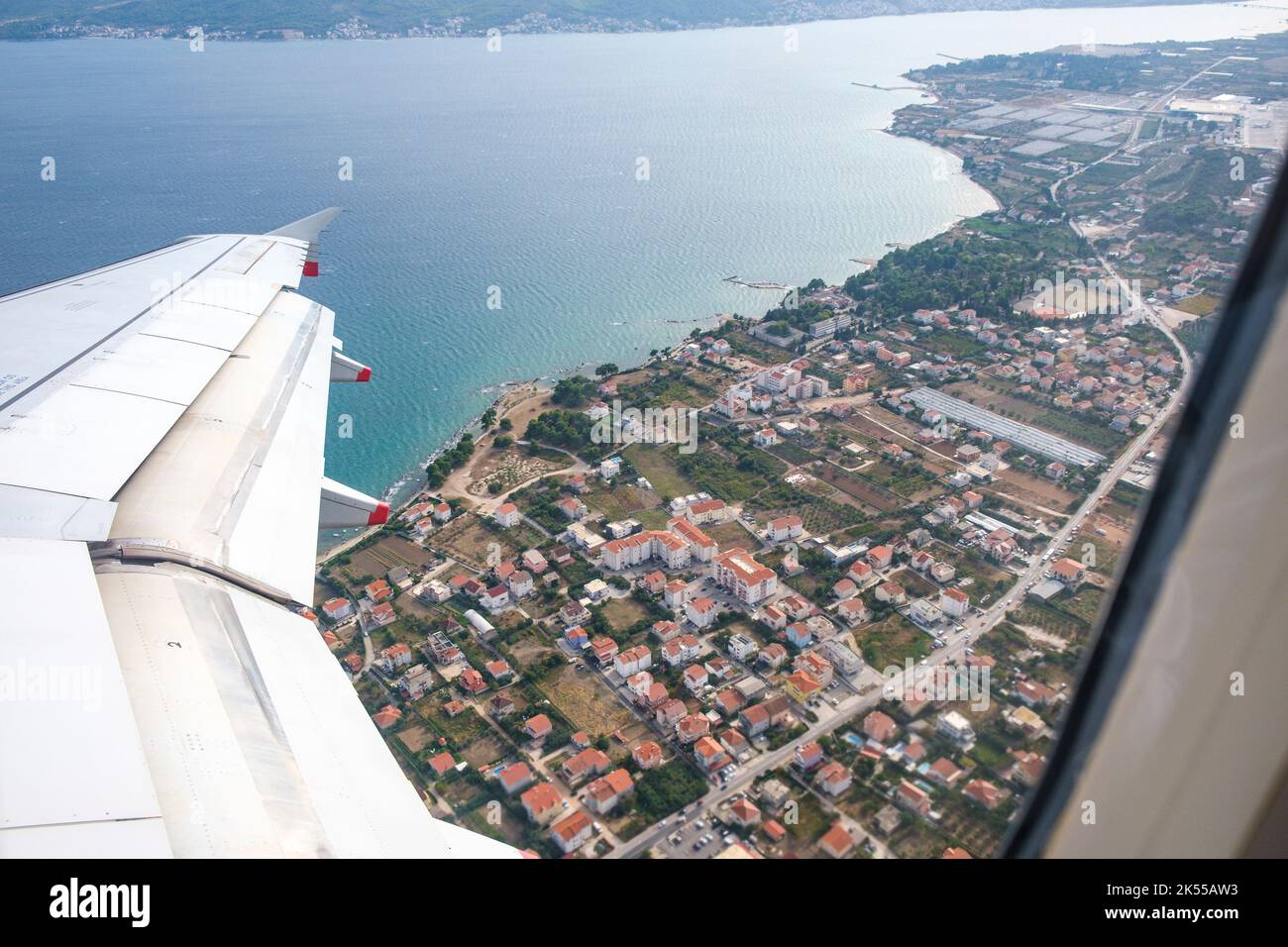 Looking out of the window of an aeroplane at the wing during take off from Split airport in Croatia. Stock Photo
