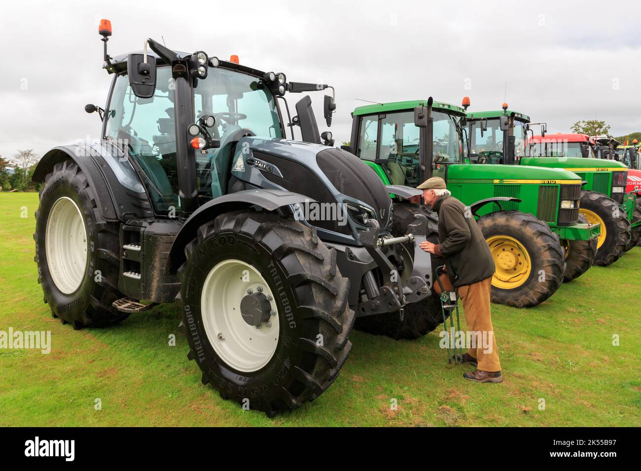 Brydkirk, Scotland - September 04, 2022: A member of the public inspecting a  Valtra N154  tractor parked up ready to take part in a charity run Stock Photo