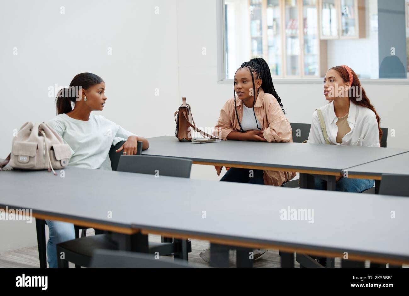 Student friends and talk in university cafeteria for course guidance and thoughts in break. Young and diverse women in friendship at education Stock Photo