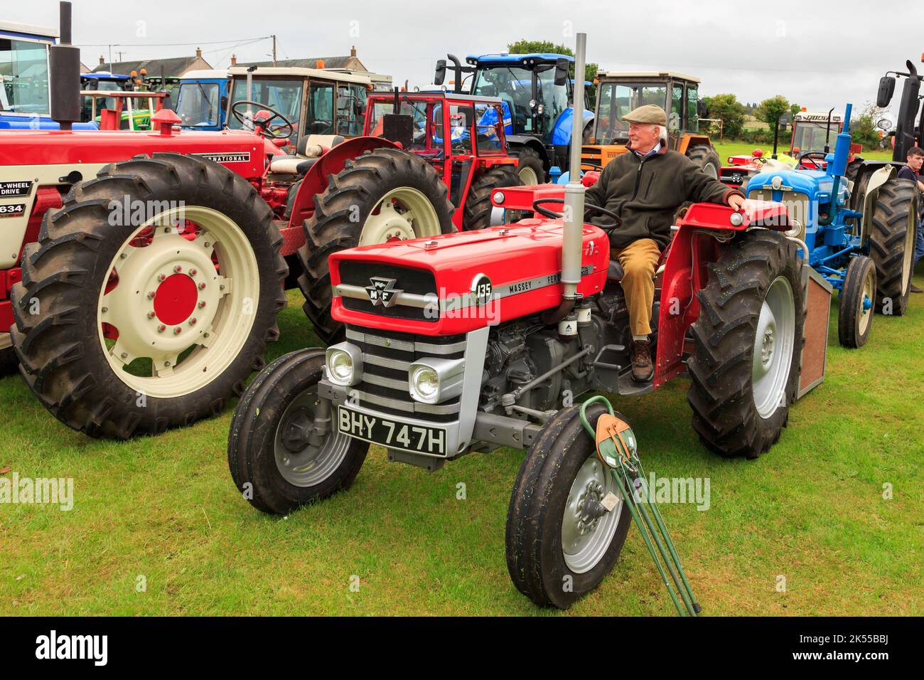 Brydkirk, Scotland - September 04, 2022: An old 1970 Massey Ferguson 135 with Gentleman sitting in the drivers seat  parked up waiting to take part in Stock Photo