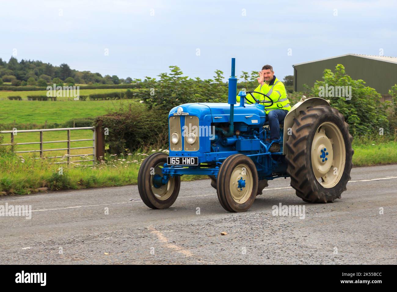 Eastriggs, Scotland - September 04, 2022: An old 1963 Fordson Super Major tractor with driver waving returning from a local charity run Stock Photo