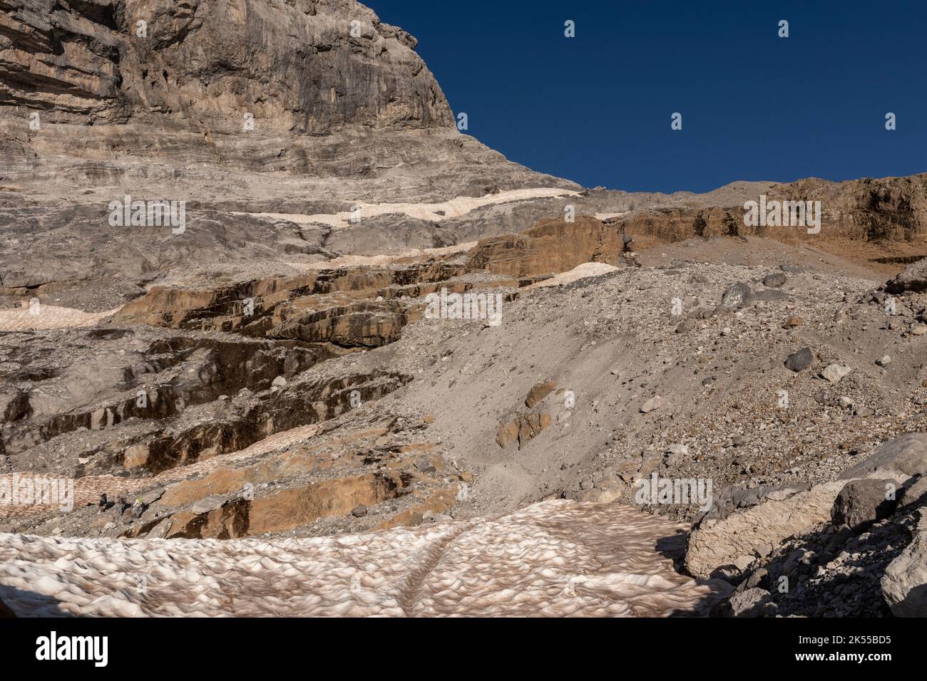 path through a snowfield in the pyrenees towards the breach of rolando in summer Stock Photo