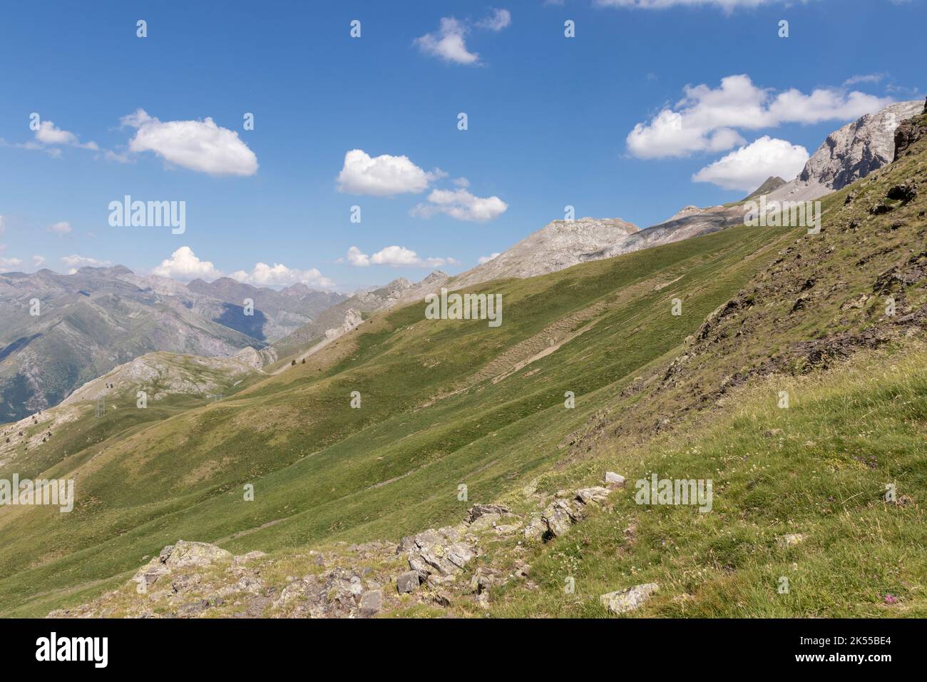 Picturesque view of the Pyrenees landscape with green meadows and mountains during the day. Summer trip in the mountains Stock Photo