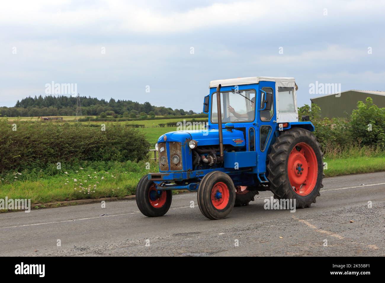 Eastriggs, Scotland - September 04, 2022: An old Fordson Power Major tractor with driver waving returning from a local charity run Stock Photo