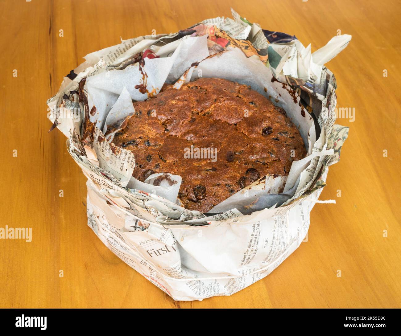 Christmas cake wrapped in newspaper to insulate while cooking Stock Photo