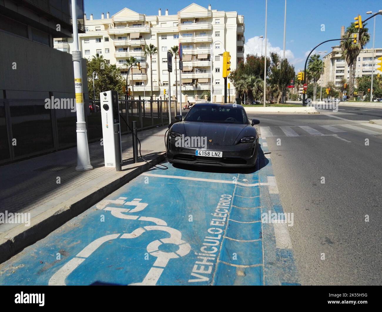 Porsche Taycan at Ibedrola charging station. Malaga, Spain Stock Photo