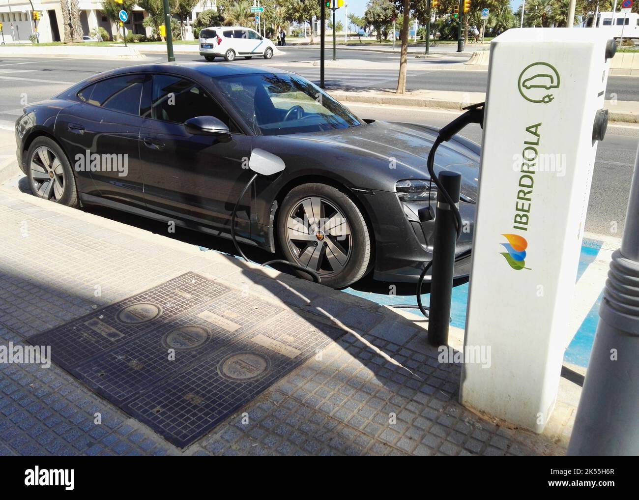 Porsche Taycan at Ibedrola charging station. Malaga, Spain Stock Photo