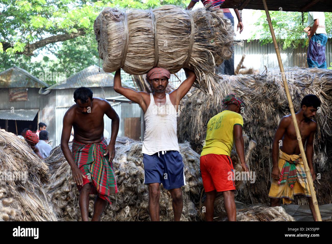 October 6, 2022, manikgonj, Manikgonj, Bangladesh A man is carrying a