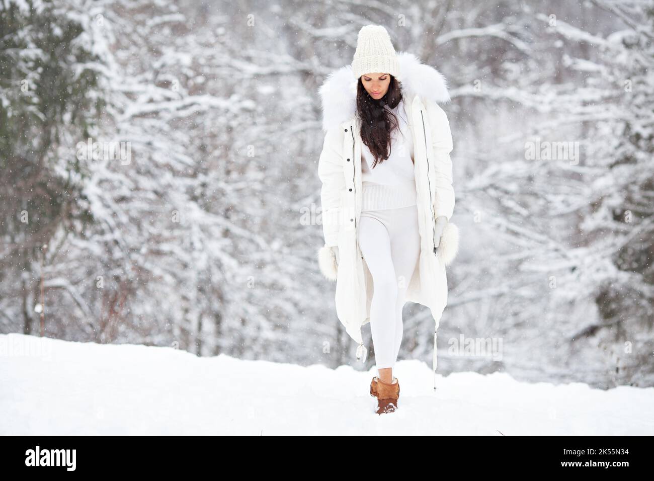 https://c8.alamy.com/comp/2K55N34/beautiful-woman-wearing-fashionable-winter-clothes-white-down-jacket-knitted-stylish-hat-sweater-leggings-mittens-felt-boots-outdoors-female-s-2K55N34.jpg