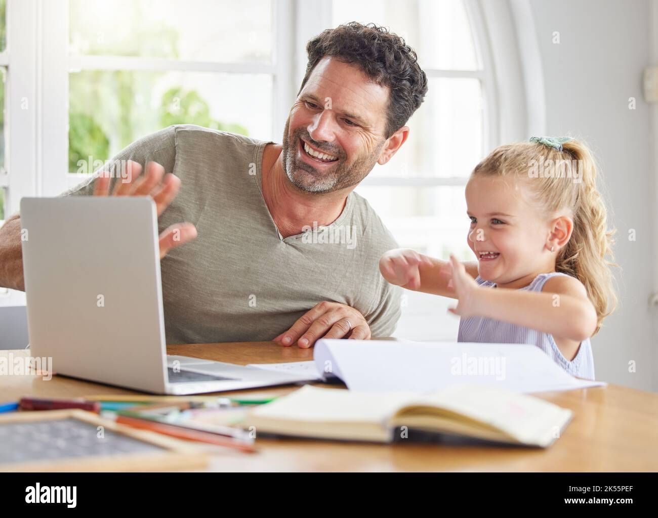 Father, girl child and e learning on laptop studying together on video conference or internet video call at house. Online home school education dad Stock Photo