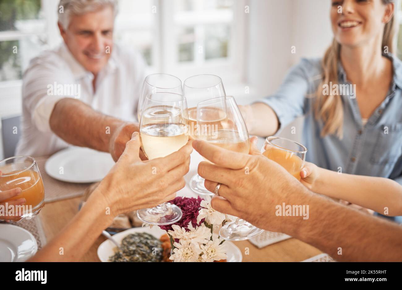 Wine, toast and happy family celebration at a table, bonding and