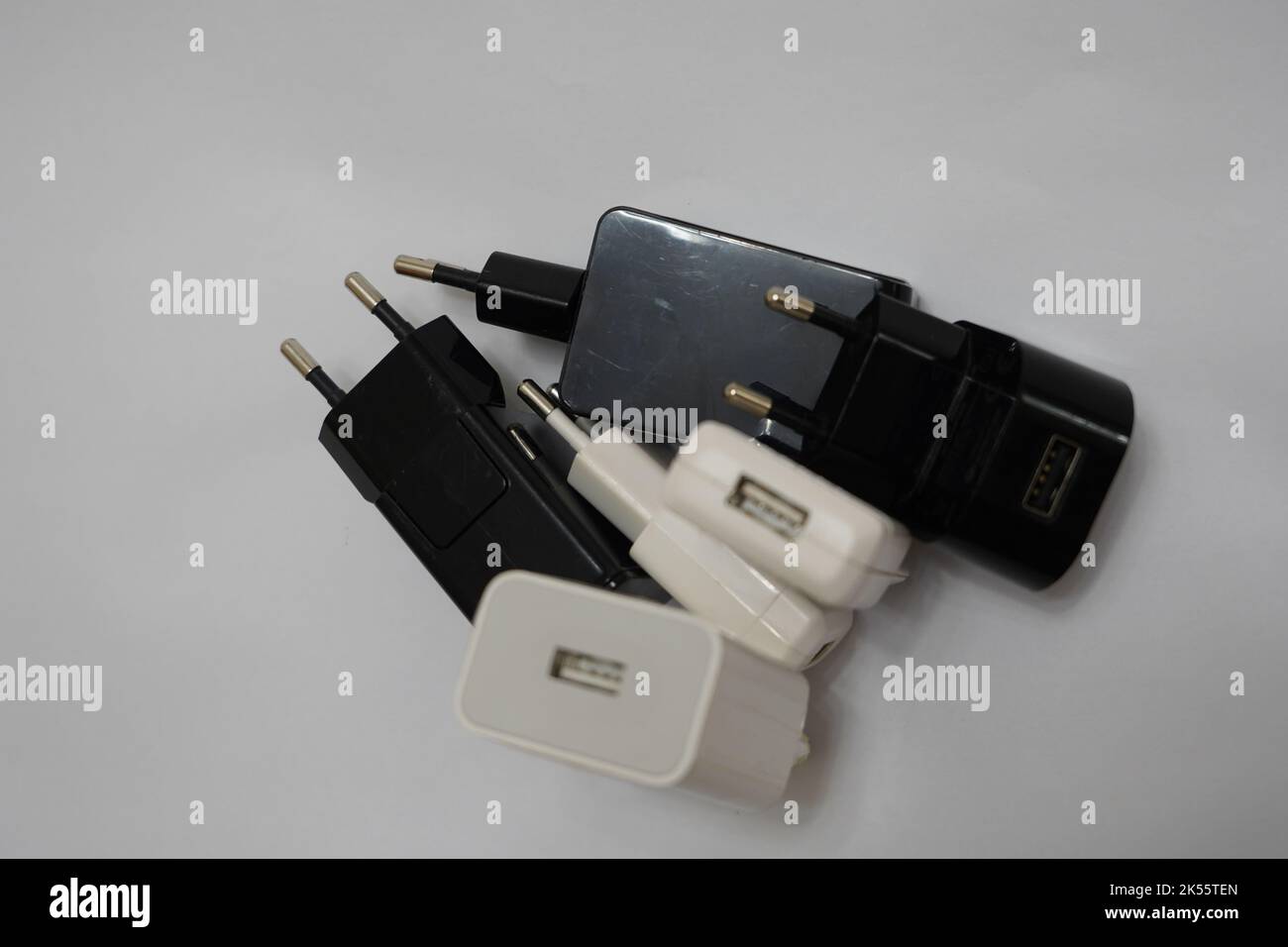 many phone charger adapters of different types on a white background