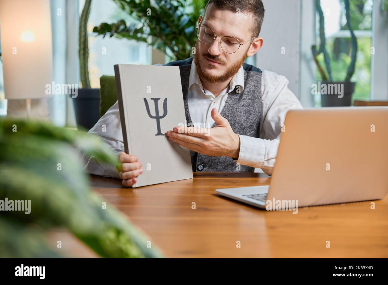 Photo of caucasian young professional psychologist sitting in home office. Concept of communication, psychology, advice, psychotherapy, session Stock Photo