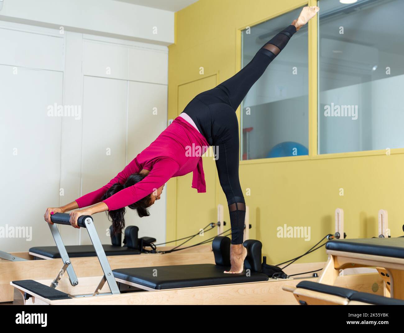 Woman training pilates on the reformer bed. Reformer pilates studio machine  for fitness workouts in gym. Fit, healthy and strong authentical body Stock  Photo - Alamy