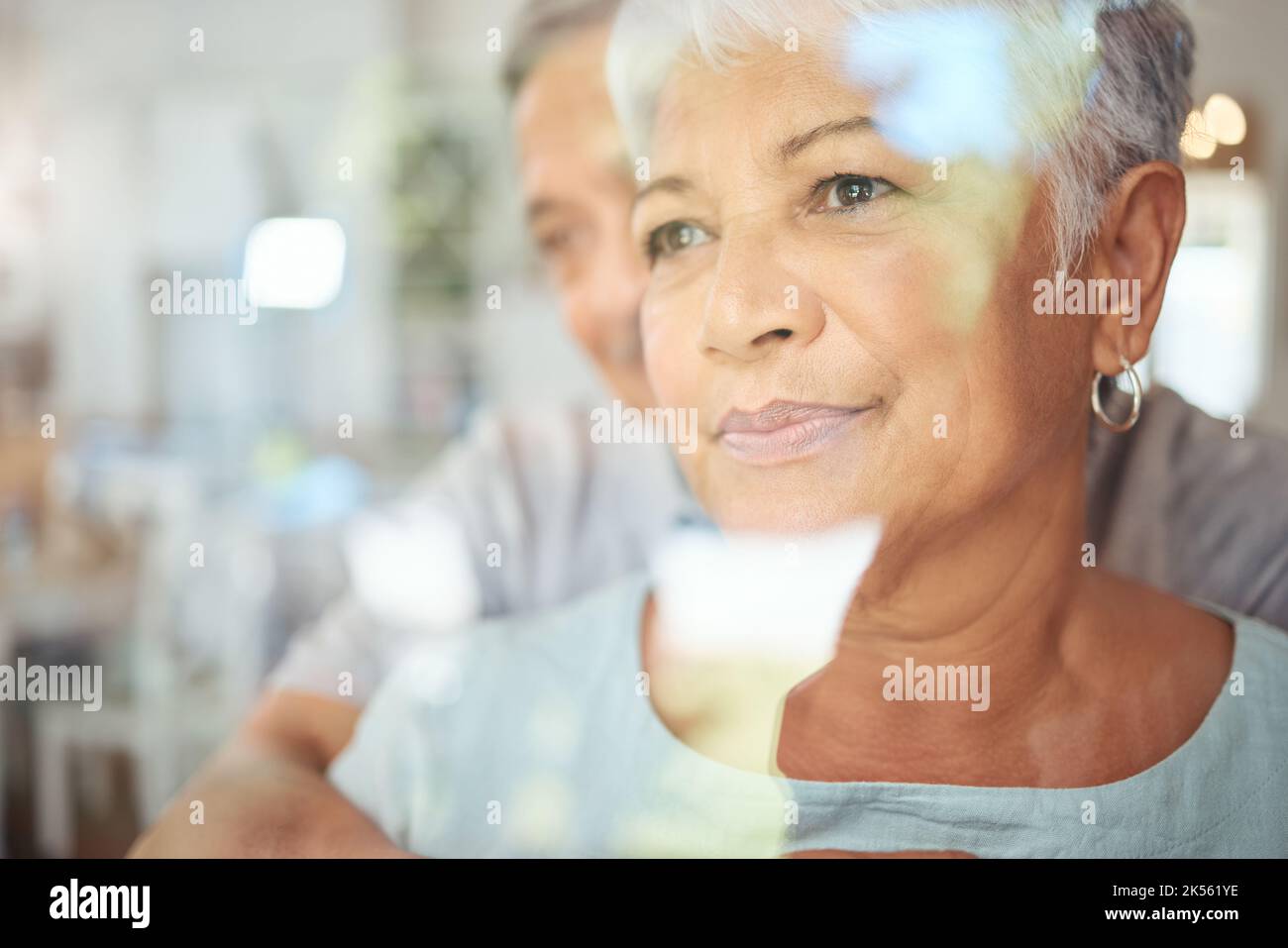 Woman thinking in home, senior couple reflection in window and man support wife grief in Brazil retirement care. Husband hug elderly life partner, sad Stock Photo