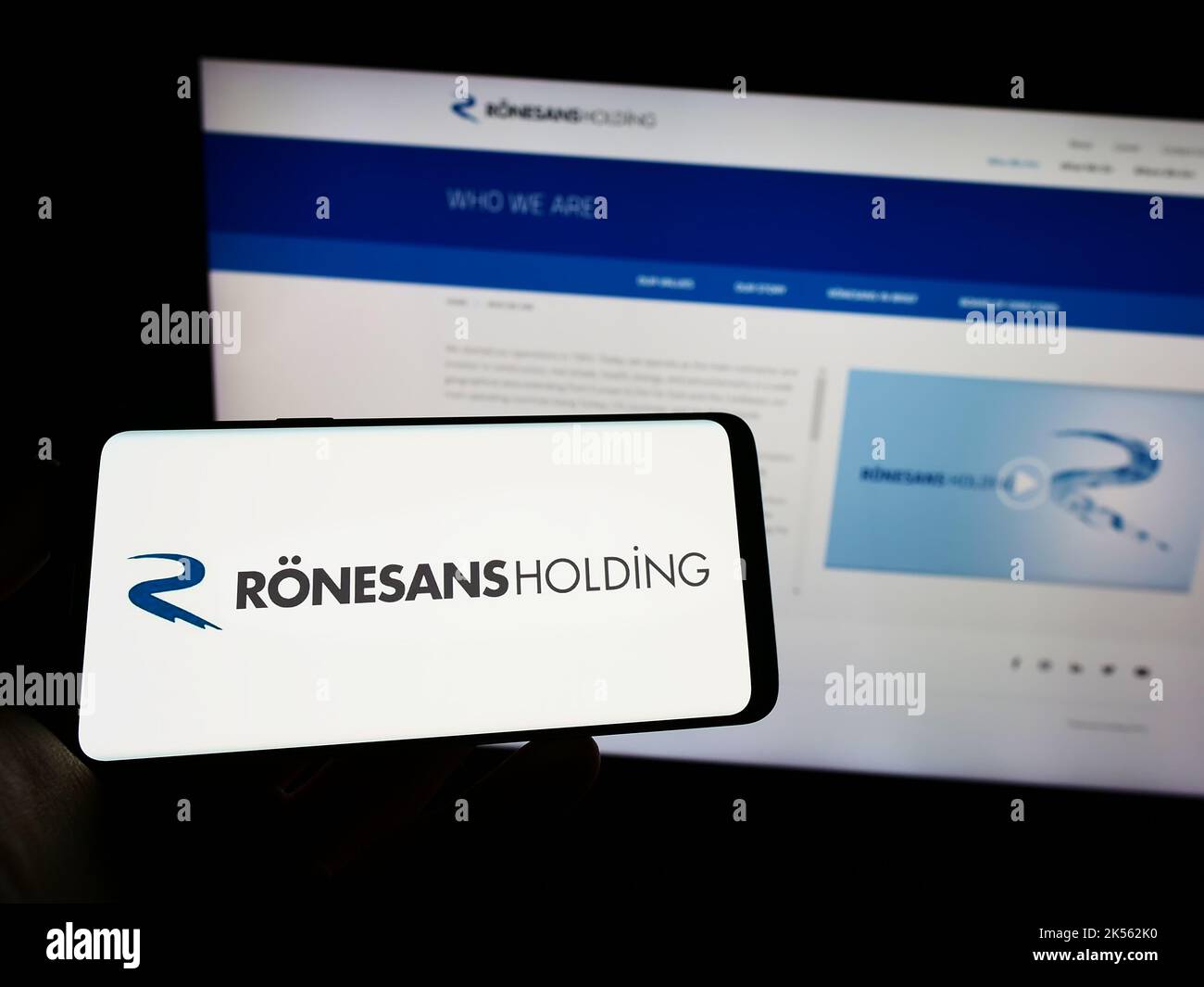 Hasan Ronesans Person holding mobile phone with logo of Turkish conglomerate Ronesans ...