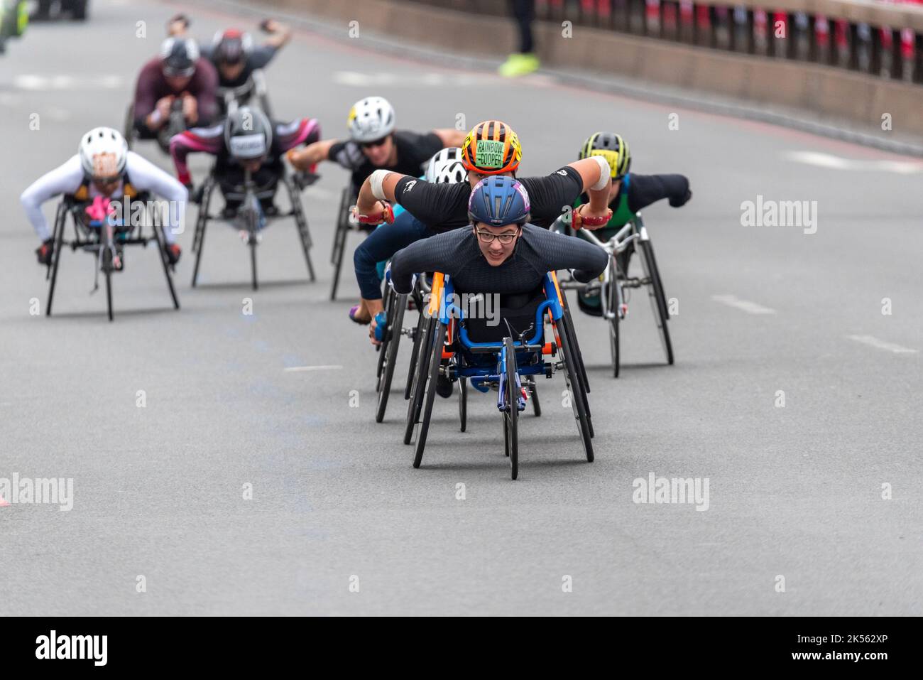 Merle Menje wheelchair athlete racing in the TCS 2022 London Marathon elite wheelchair race in Tower Hill, London, UK. Leading a group of athletes Stock Photo