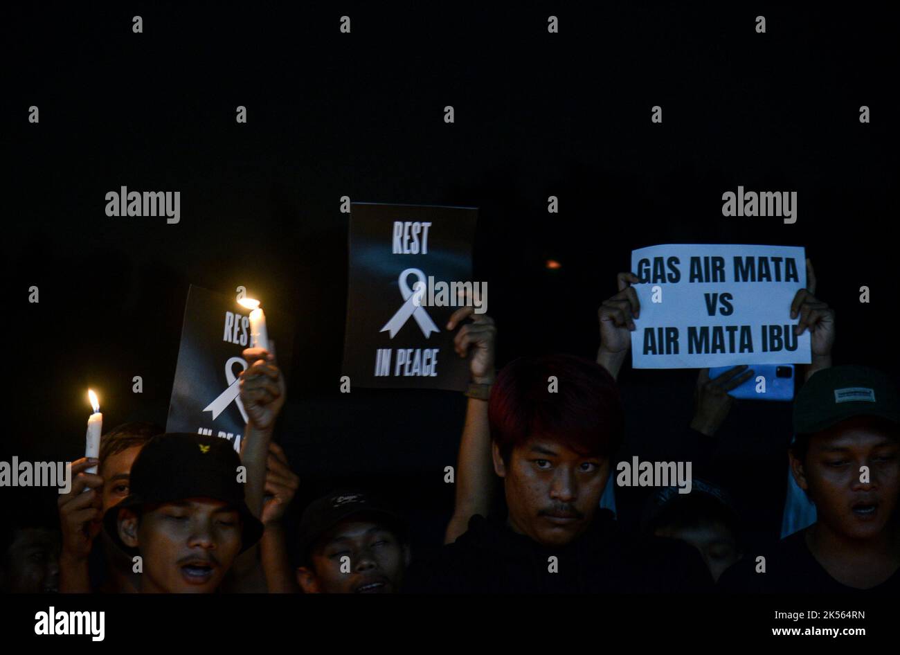 Bogor, Indonesia. 04th Oct, 2022. Football supporters hold candlelight