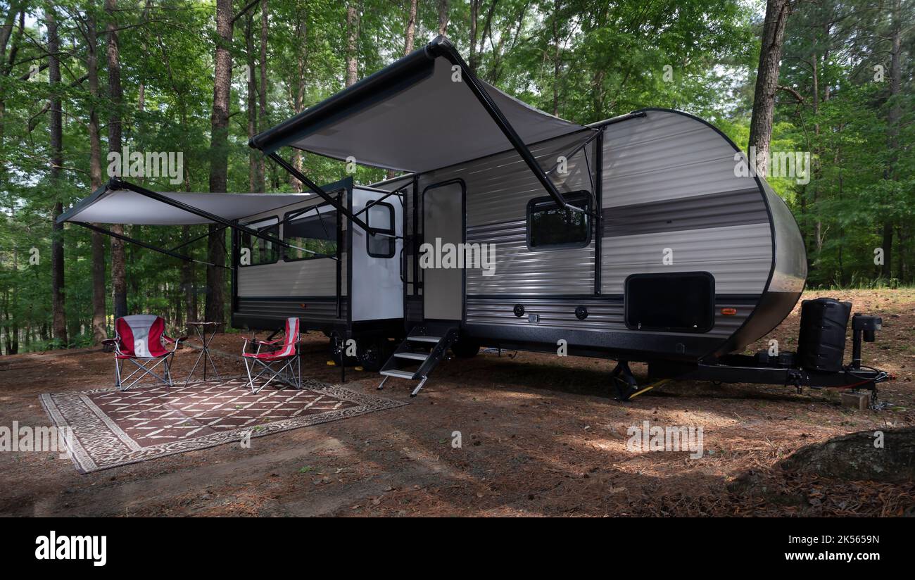 Camper trailer set up with awnings out at a campsite at Jordan Lake