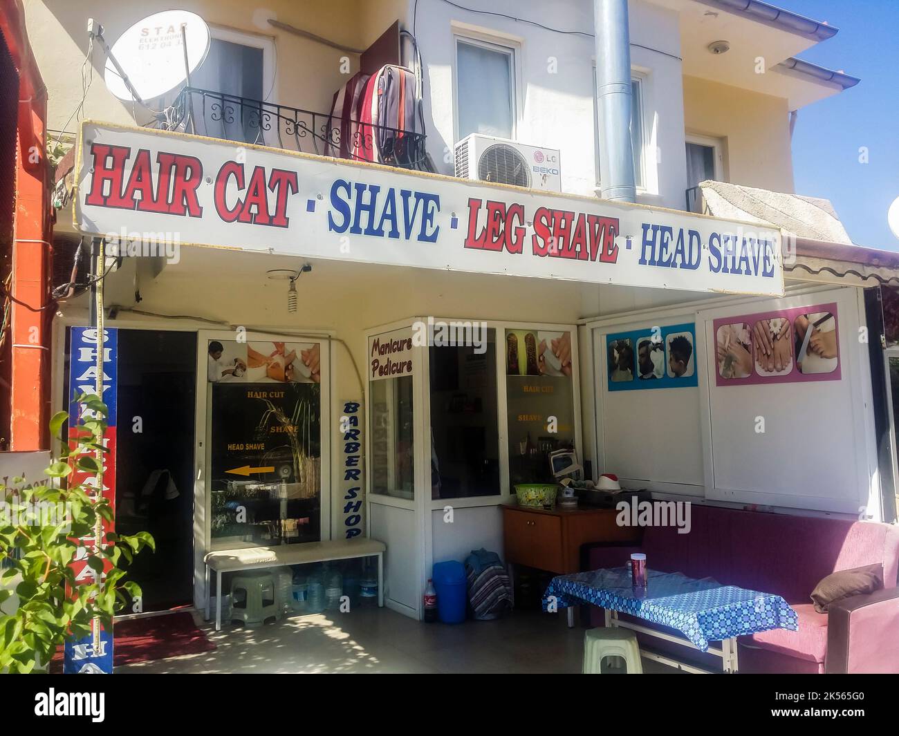 Sign outside a Turkish Barber shop 'Hair cat , shave, leg shave, head shave' Stock Photo