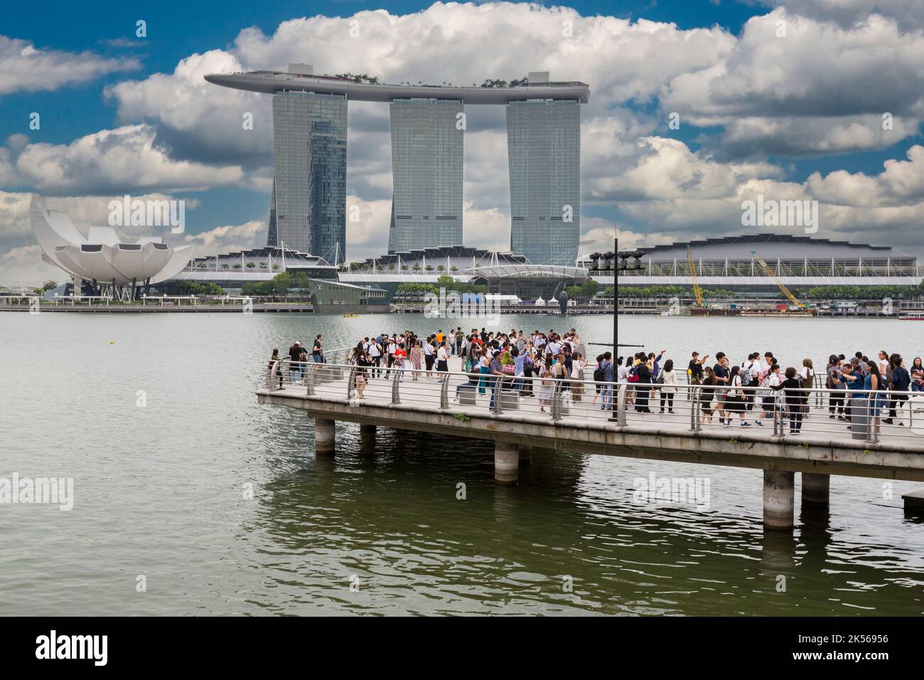 Marina Bay Sands, ArtScience Museum far left, Tourists on Viewing Platform in foreground.  Singapore. Stock Photo