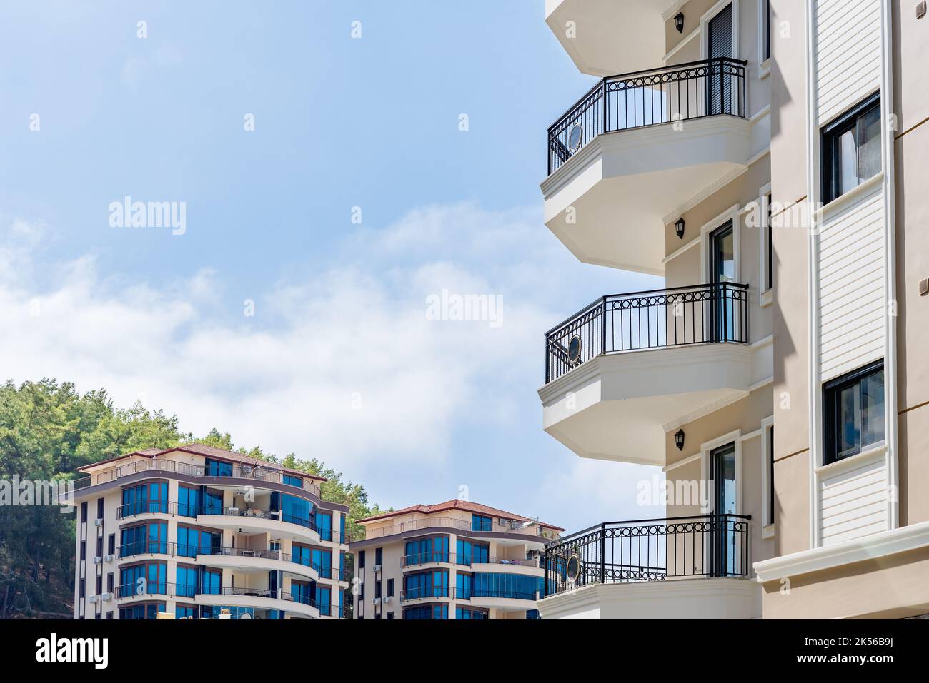 Cityscape of a residential area with modern apartment buildings, green