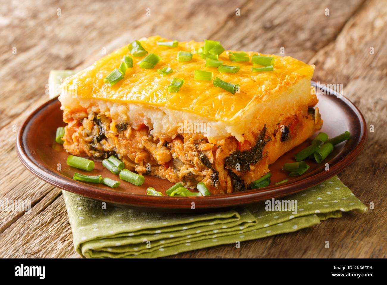 casserole of mashed potatoes with minced meat and vegetables on top with cheese close-up on a plate on the table. horizontal Stock Photo
