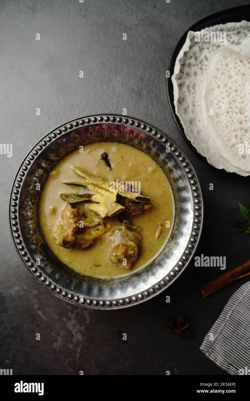 Lamb stew or Mutton in coconut milk gravy served with Appam- Kerala breakfast Stock Photo