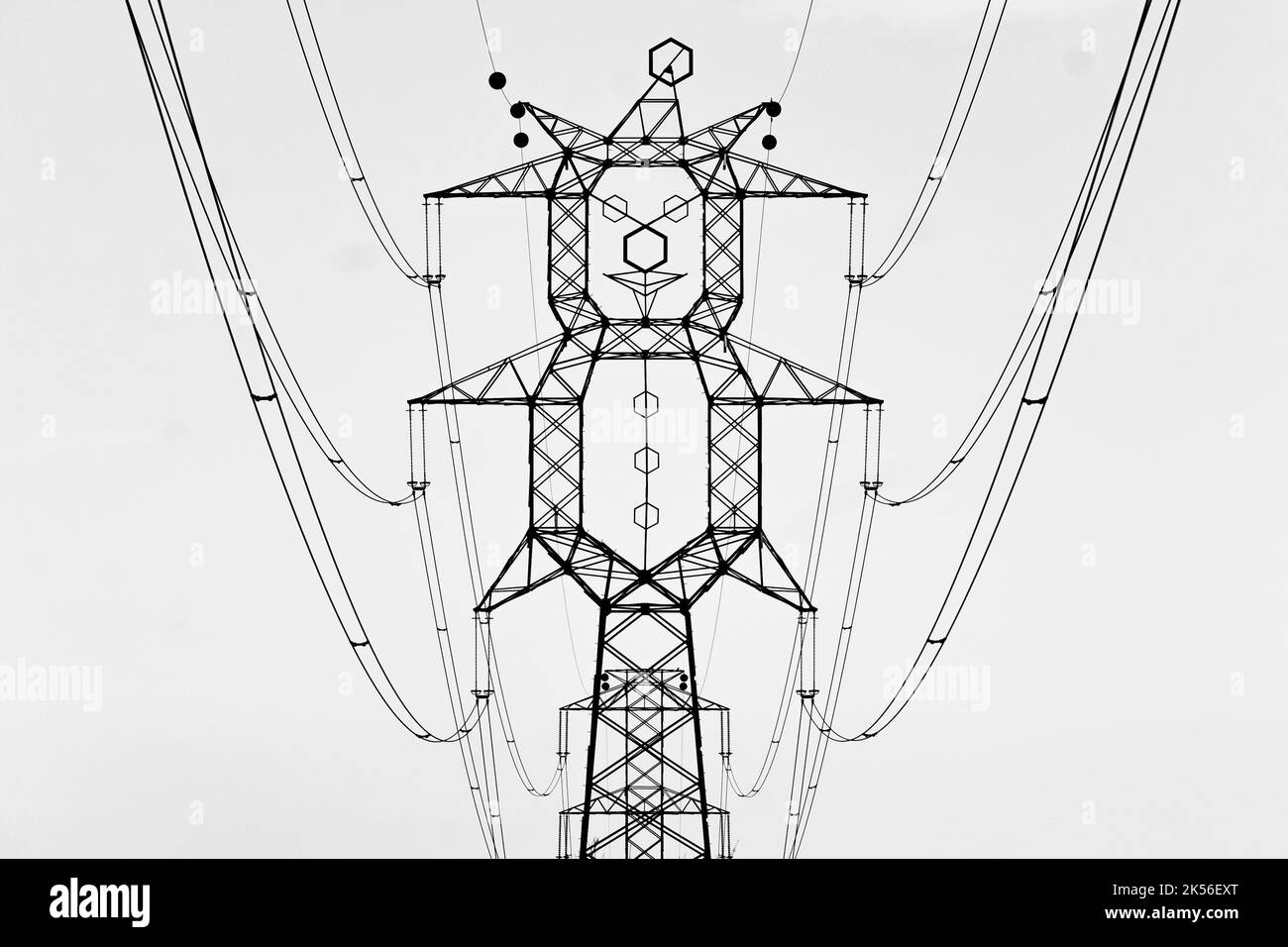 clown shape high voltage power lines high voltage electrical transmission tower next to M5 highway in Pusztavacs town hungary Stock Photo