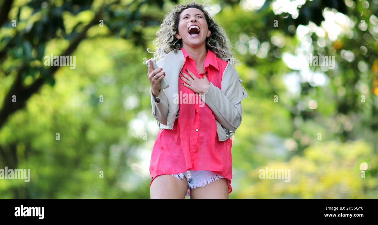 Excited woman jumping celebrating success hi-res stock photography and ...