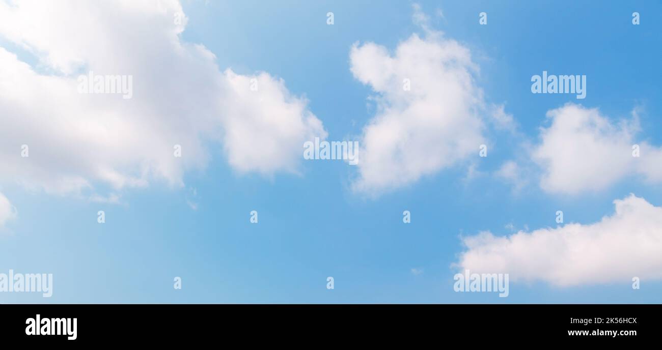 Blue sky with white cumulus clouds on a sunny day. Natural panoramic ...