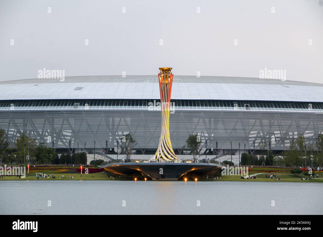 Chengdu, China - 4th October 2022: The torch tower lit up in yellow and orange in front of Dong’an Stadium, one of the main venues of the Chengdu 2021 Stock Photo