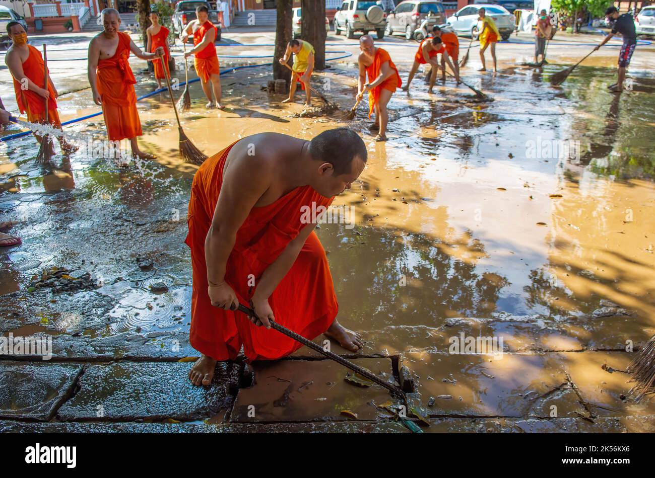 Monks clean up a temple in Chiang Mai's Muang district during the aftermath. The flood situation at Chiang Mai in the northern part of Thailand comes to an ease with decreasing water levels. The floods damaged commercial areas, the Chang Khlan Road and the Night Bazaar. Stock Photo