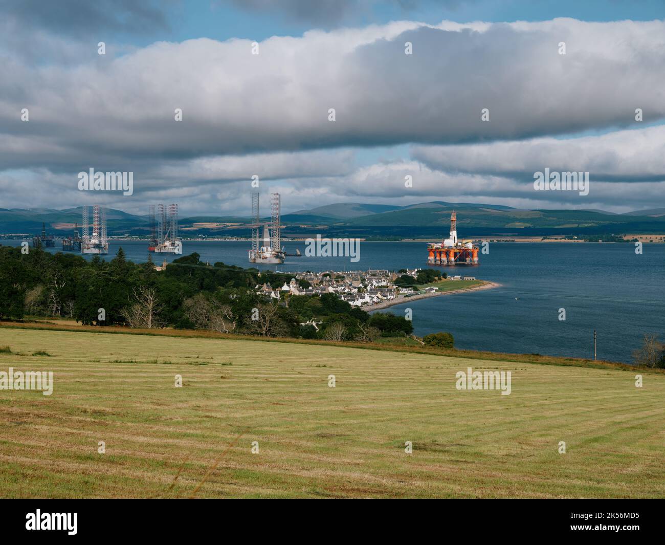 The summer farming landscape and coastline of the Cromatry Firth with layed up oil rigs, Cromarty, Black Isle, Ross and Cromarty, Highland Scotland UK Stock Photo