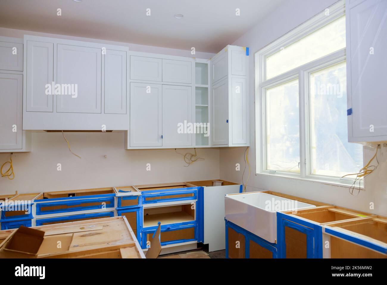 Installation of white kitchen cabinets furniture interior Stock Photo ...
