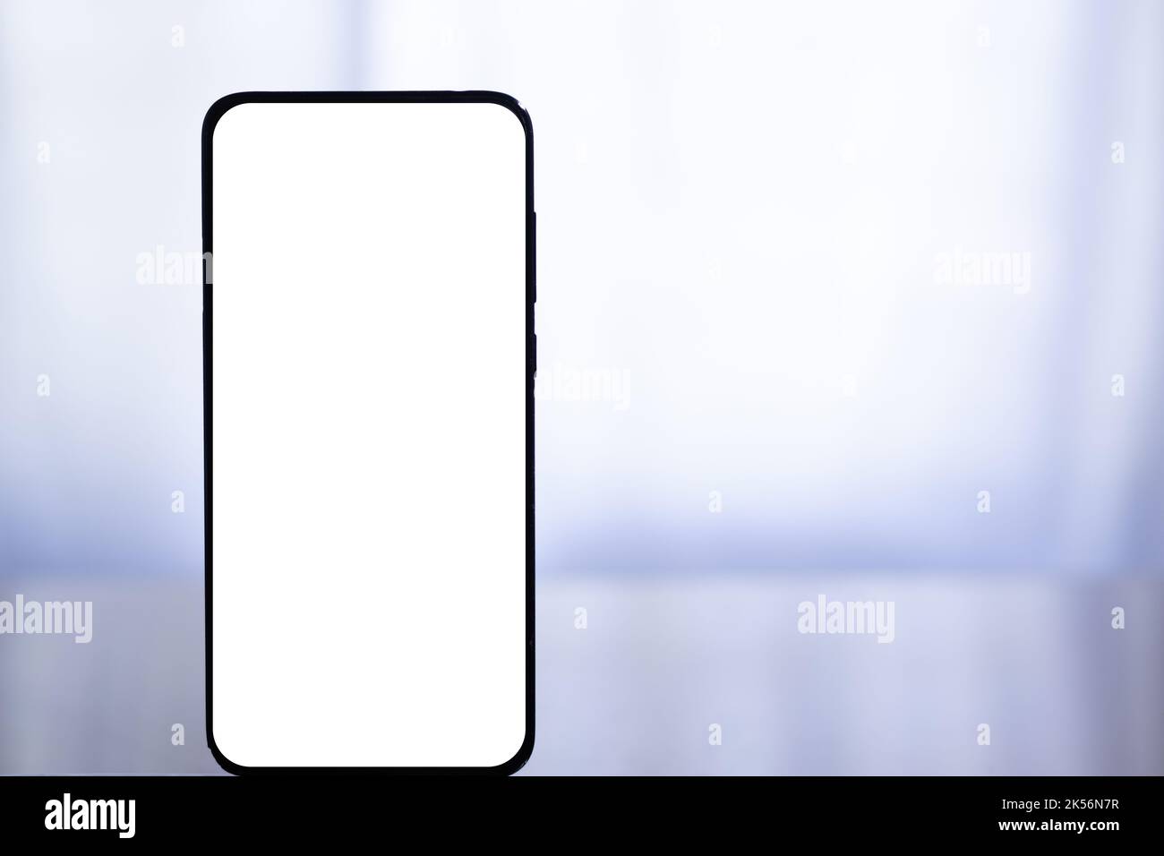 Close up of a white blank smart phone screen on a isolated white ...